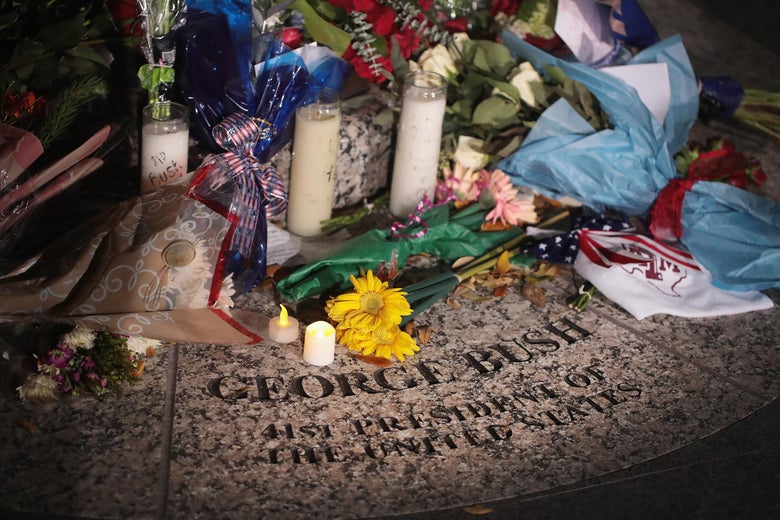 Flowers are left at the base of a statue of President George H.W. Bush on the campus of Texas A&M University outside the George H.W. Bush Presidential Library Center on December 1, 2018 in College Station, Texas.